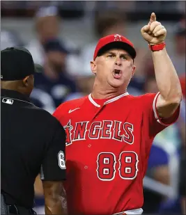  ?? TODD KIRKLAND – GETTY IMAGES ?? Angels interim manager Phil Nevin argues with an umpire and is ejected during the fifth inning of Saturday’s game against the Braves in Atlanta.