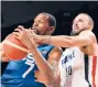  ?? ROBERT GAUTHIER/TNS ?? Kevin Durant, left, tangles with France’s Evan Fournier on Sunday.