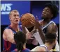  ?? CARLOS OSORIO — THE ASSOCIATED PRESS ?? Warriors center James Wiseman grabs a rebound next to Detroit Pistons center Mason Plumlee, left, on Tuesday in Detroit.