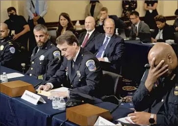  ?? Brendan Smialowski Pool Photo ?? METROPOLIT­AN Police Officer David Hodges, center, read the definition of “terrorist” in U.S. code to justify his use of the term to describe the Jan. 6 Capitol rioters during Tuesday’s House select committee hearing.