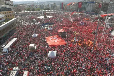  ?? — AFP ?? Supporters of various political parties shout slogans and hold Turkish flags and pictures of Ataturk, founder of modern Turkey, in Istanbul’s Taksim Square on Sunday during the first cross-party rally to condemn the coup attempt against President Recep...