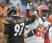  ?? PHIL MASTURZO / BEACON JOURNAL ?? Browns left tackle Desmond Harrison and Steelers lineman Cameron Heyward point at each other during Sunday’s penalty-filled tie.