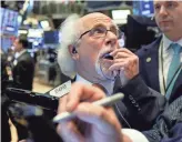  ?? RICHARD DREW/AP ?? Trader Peter Tuchman works on the floor of the New York Stock Exchange on Tuesday. The Dow slid 505 points at its low.