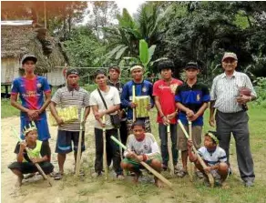  ??  ?? The junior hockey team — the sticks were carved out from wood!