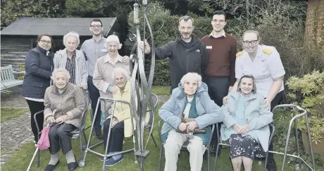  ??  ?? Kurt Lightfoot with residents and staff at Florence House.