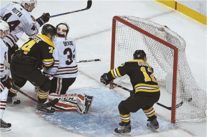  ?? STAFF PHOTOS BY JOHN WILCOX ?? BARRAGE OF GOALS: Bruins winger Brian Gionta (12, above) scores the eventual gamewinner on a power play past goalie J-F Berube, and winger David Pastrnak (88, right) is congratula­ted by Rick Nash (61) and Danton Heinen (43) after scoring in the third...