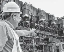  ?? Austen Leake / Associated Press ?? Mike Wertz is demolition manager for the Duke Energy Wabash River Station in Terre Haute, Ind. Duke plans to cut its carbon emissions, but some environmen­talists are skeptical.