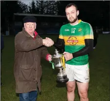  ??  ?? Kilcoole captain Daniel Kavanagh is presented with the Swan Cup.