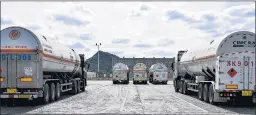  ?? QILAI SHEN/BLOOMBERG ?? LNG tanker trucks sit outside an ENN Energy terminal on Zhoushan Island, China.