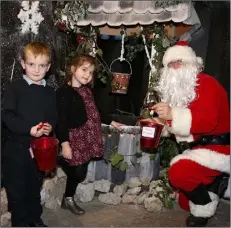  ??  ?? Oran and Sophia helping Santa at the Wishing Well in Santa’s Winter Wonderland in Kilcannon Garden Centre.