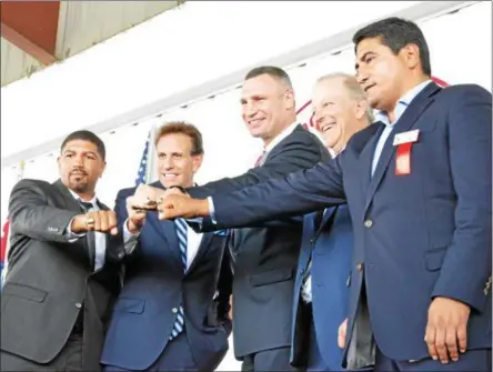  ?? JOHN BREWER - ONEIDA DAILY DISPATCH ?? From left, Internatio­nal Boxing Hall of Fame Class of 2018induct­ees Ronald Wright, Steve Albert, Vitali Klitschko, Jim Gray, and Erik Morales present their Hall of Fame rings to the crowd gathered in Canastota, New York on Sunday, June 10.