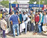  ?? ANI ?? People arrive at a petrol station with empty containers amid a fuel shortage, in Srinagar on Thursday.