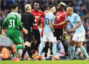  ??  ?? Players face-off during a past Manchester derby between United and City in the English Premier League
