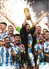  ?? AP ?? Lionel Messi and Argentina celebrate after beating France in the 2022 World Cup. FIFA changed the 2026 group-stage format from 16 groups of three teams to 12 groups of four teams.