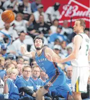  ?? [PHOTO BY BRYAN TERRY, THE OKLAHOMAN] ?? Oklahoma City’s Alex Abrines passes the ball Wednesday as Utah’s Joe Ingles defends.