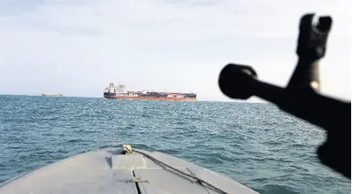  ?? AP ?? In this July 21, 2019, file photo, a speedboat of Iran’s Revolution­ary Guard trains a weapon towards the Britishfla­gged oil tanker ‘Stena Impero’, which was seized in the Strait of Hormuz on July 19 by the Guard, in the Iranian port of Bandar Abbas.