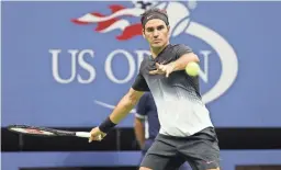  ?? AP FILE ?? Roger Federer makes a return against Philipp Kohlschrei­ber in a fourth-round match at the U.S. Open in New York on Sept. 4, 2017.