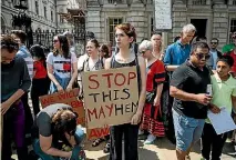  ?? PHOTO: GETTY IMAGES ?? Protesters hold placards during a demonstrat­ion on Whitehall against Prime Minister Theresa May.