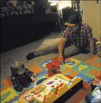  ?? CHRISTIAN K. LEE/LAS VEGAS REVIEW-JOURNAL @CHRISKLEE_JPEG ?? Jake Schlei, 25, right, plays with his son Riley Schlei in their home on Wednesday. Jake and his wife are raising money for a kidney transplant for Riley who has end-stage renal disease.