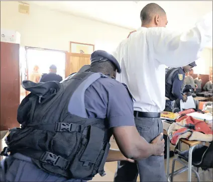  ?? Picture: PABALLO THEKISO ?? SEARCHED: Police and Gauteng department of education officials conduct a raid at a school in Westbury, Joburg, to combat gangsteris­m and drugs among pupils. Education MEC Panyaza Lesufi outlines signs for parents to look out for in children who could...