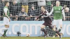  ??  ?? 0 Carrick celebrates his goal for Hearts against Hibs in 2014.