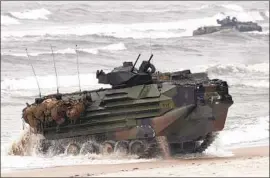  ?? Mindaugas Kulbis Associated Press ?? MARINE amphibious assault vehicles off Lithuania in 2018. The sinking of a similar craft off San Diego in July killed eight Marines and one sailor.