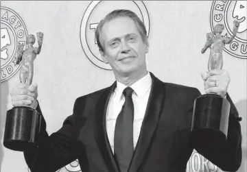  ?? By Dan Macmedan, USA TODAY ?? Two-fisted winner: Steve Buscemi would not let go of his Boardwalk Empire trophies, but he did give up his glass of wine.