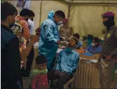  ?? ALTAF QADRI — THE ASSOCIATED PRESS ?? A health worker takes a nasal swab sample of a passenger to test for COVID-19 at a bus terminal in New Delhi, India, on Wednesday.