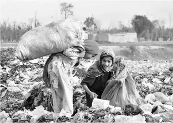  ??  ?? Children look for a living in garbage in Pakistan. — Ashfaq Yusufzai/IPS photo