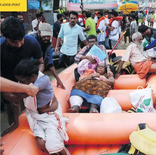  ?? AFP / GETTY IMAGES ?? Indian residents are evacuated by rescue workers in Paravoor in the south Indian state of Kerala on Sunday, as the region recovers from substantia­l flooding. Rescuers waded into submerged villages in a search for survivors cut off for days by floods that have already killed more than 350 people.