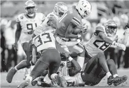  ?? D.A. VARELA dvarela@miamiheral­d.com ?? UM quarterbac­k Jacurri Brown, here rushing against Florida State on Nov. 5, could start Saturday against Clemson while Tyler Van Dyke continues to heal his arm.