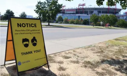  ?? Photograph: Christophe­r Hanewincke­l/USA Today Sports ?? A Covid mask sign is seen in the parking lot of Nissan Stadium on the originally scheduled day of the the Tennessee Titans game against the Pittsburgh Steelers. The game was reschedule­d for 25 October at Nissan Stadium.