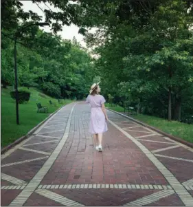  ?? Submitted photo ?? WANDERING: Blogger “One Girl Wandering,” also known as Lindsay, is shown walking the Grand Promenade while documentin­g her visit to Hot Springs in June.