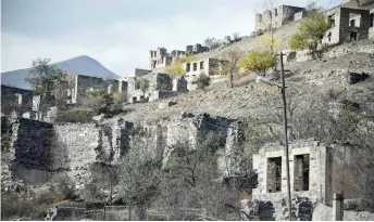  ?? Photo — AFP file ?? General view of destroyed Azerbaijan­i houses after Amenia captured the district in 1994, in the town of Kalbajar during the military conflict between Armenia and Azerbaijan over the breakaway region of Nagorno-Karabakh.