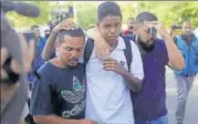  ?? REUTERS ?? People embrace in front of the training centre of Rio's football club Flamengo, after a deadly fire in Rio de Janeiro on Friday.