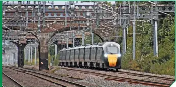  ?? MARK PIKE. ?? Under a tangle of overhead line equipment, GWR 800314 approaches Twyford with a London Paddington to Swansea service on September 18 2018. The Class 800s and Class 802s for GWR are built by Hitachi.