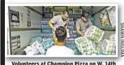  ??  ?? Volunteers at Champion Pizza on W. 14th St. load donated supplies onto truck bound for airport and then Puerto Rico.