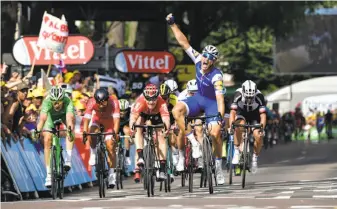  ?? Philippe Lopez / AFP / Getty Images ?? Germany’s Marcel Kittel celebrates as he hits the finish line ahead of France’s Arnaud Demare (left in green jersey), France’s Nacer Bouhanni and Germany’s Andre Greipel.