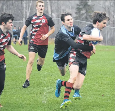  ?? KEVIN ADSHADE/THE NEWS ?? Mike MacGillivr­ay of the NRHS Nighthawks gets tackled by an NNEC Gryphons defender in high school rugby play on Thursday. MacGillivr­ay had a try in this game for NRHS, who pulled away in the second half in a 34-14 victory.