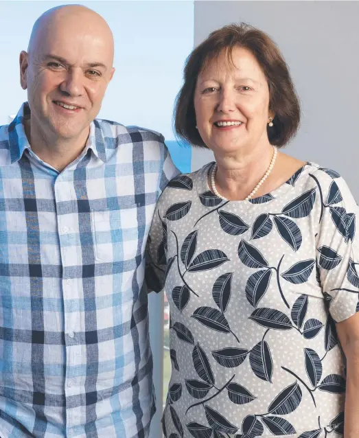  ?? ?? Gerrard and his wife, Bond University law lecturer, Anthea; and (far left) Gerrard suits up ready to head into the red zone of the ebola treatment centre in Sierra Leone. Main picture: David Kelly