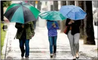  ?? AP/RICH PEDRONCELL­I ?? After years of drought, umbrellas are ubiquitous this year in California, where too much rainfall has washed out salad-making produce, like lettuce and broccoli.