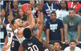  ?? MARK J. REBILAS/USA TODAY SPORTS ?? Gonzaga guard Nigel Williams-Goss goes up for a shot as South Carolina forward Chris Silva tries to defend Saturday during the semifinals of the Final Four at Glendale, Ariz. Williams-Goss scored 23 points.