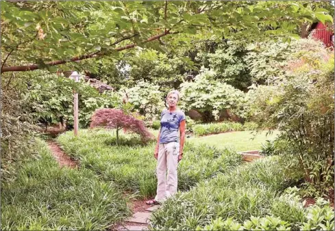  ?? AFP ?? Anna Burger stands in her ‘rewilded’ garden, a type of garden aimed at restoring and protecting natural processes, in Takoma Park, Maryland.