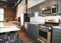  ?? ?? The kitchen has stainless-steel appliances and a large island.