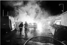  ?? TSAFRIR ABAYOV THE ASSOCIATED PRESS ?? Israeli firefighte­rs work at the scene where a rocket fired from the Gaza Strip hit Sderot, Israel, on Monday.