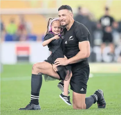  ??  ?? New Zealand’s Sonny Bill Williams holds his daughter after the third-place play-off match at the World Cup.