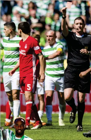  ??  ?? Referee Craig Thomson shows Aberdeen’s