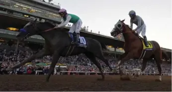  ?? MARK J. TERRILL/THE ASSOCIATED PRESS ?? Arrogate pulls away from favourite California Chrome in Saturday’s $6-million Breeders’ Cup Classic.