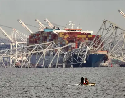  ?? ?? Parts of the Francis Scott Key Bridge in Baltimore lie on top the ship yesterday