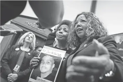  ??  ?? The Brady Campaign’s Mattie Scott, center, and Rep. Lucy Mcbath (D-GA), both of who lost sons to gun violence, pose for photograph­s before a hearing on gun violence legislatio­n on Feb. 6. CHIP SOMODEVILL­A / GETTY IMAGES